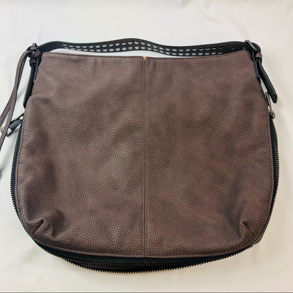 Black Rivet purse/satchel brown color with a purpleish hue.Zipper expansion